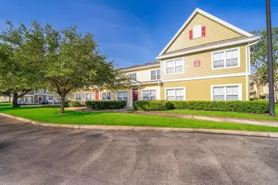 a large house with a street in front of it at Charming 3BrTownhome near Disney in Kissimmee