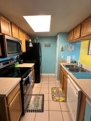 a kitchen with a sink and a stove at Bright Condo near Disney and Universal in Kissimmee