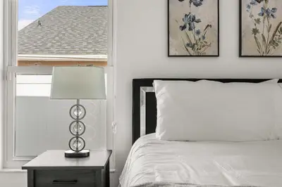 a bedroom with a bed and a table with a lamp at Residentas Indian Creek in Kissimmee