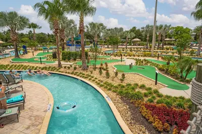 a pool at the resort with people playing golf at 4BR Pool Home Ideal for Families in Kissimmee