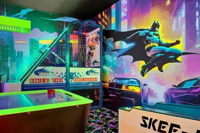 a game room with a batman painting on the wall at Epic Disney Themehouse in Windsor (ADA option) in Orlando