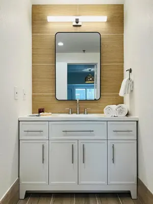 a bathroom with a white sink and a mirror at Condo near Epic & Universal,free parking & Netflix in Orlando