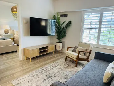 a living room with a flat screen tv on a wall at Condo near Epic & Universal,free parking & Netflix in Orlando