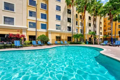 a swimming pool in front of a building at Condo near Epic & Universal,free parking & Netflix in Orlando
