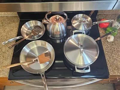a group of pots and pans on a stove at Stunning waterfront Views 1 mile to Disney 2 bath in Orlando