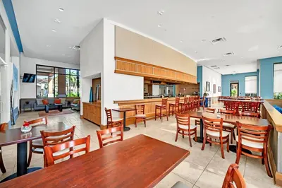 a restaurant with tables and chairs and a bar at Waterfront ParadiseClose 2 DisneyGated Community in Orlando