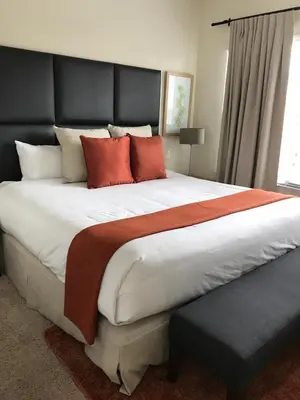 a large bed with red pillows in a bedroom at Waterfront ParadiseClose 2 DisneyGated Community in Orlando