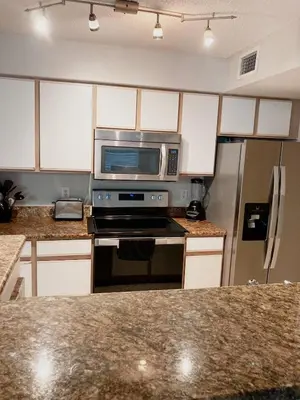 a kitchen with a microwave and a refrigerator at Villa Velera in Kissimmee
