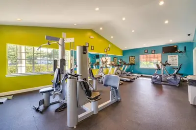 a gym with several tread machines in a room at Villa Velera in Kissimmee