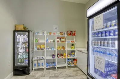 a store with a refrigerator and shelves of drinks at Emerald Island Resort 6 Bed Pool & Spa villa in Kissimmee