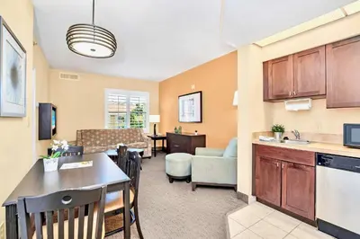 a living room with a kitchen and a dining room at Suite near Universal Studios with Pool & Hot Tub in Orlando