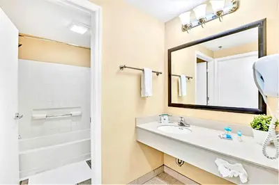 a bathroom with a sink and a mirror at Modern Condo close to Disney with Arcade and BBQ Grill in Orlando