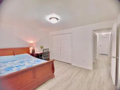 a bedroom with a bed and a desk and a table at Happy Home in Orlando