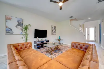 a large couch in a living room with a tv at Bellavida Resort Retreat with Private Pool in Kissimmee