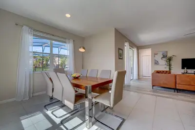 a dining room with a wooden table and chairs at Bellavida Resort Retreat with Private Pool in Kissimmee