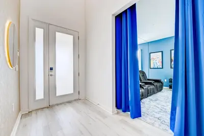 a living room with blue curtains and a couch at Bellavida Resort Retreat with Private Pool in Kissimmee
