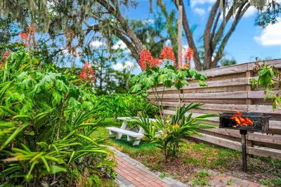 a wooden fence with a bench in a garden at Serenity Spring Lake King Suite in Orlando