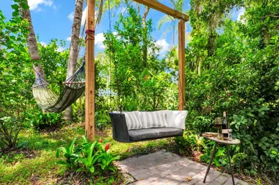 a hammock hanging from a pergola in a garden at Serenity Spring Lake King Suite in Orlando