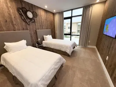 a hotel room with two beds and a tv at Luxurious 4bed Villa Just 10 Minutes from Disney! Private BBQ in Orlando