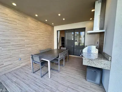 a dining room with a table and chairs and a counter at Luxurious 4bed Villa Just 10 Minutes from Disney! Private BBQ in Orlando