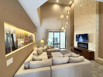 a large living room with a large white couch at Luxurious 4bed Villa Just 10 Minutes from Disney! Private BBQ in Orlando