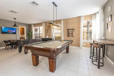 a living room with a pool table in it at 6BR Fun Villa – Game Room, Pool, Near Parks in Kissimmee
