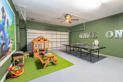 a game room with a ping pong table and a ping pong tableablish at 6BR Fun Villa – Game Room, Pool, Near Parks in Kissimmee