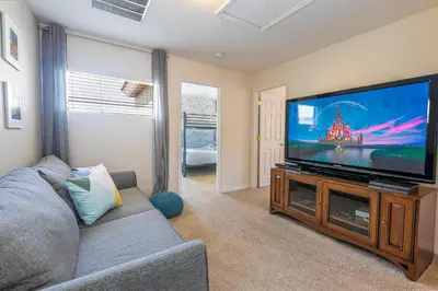 a living room with a large flat screen tv at 6BR Fun Villa – Game Room, Pool, Near Parks in Kissimmee