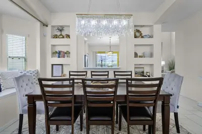 a dining room with a table and chairs at Luxurious Family Resort Getaway in Kissimmee