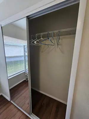 a closet with a mirror in a room at Magical Getaway- Cozy Home Minutes from Disney, Restaurants & Outlets! in Kissimmee
