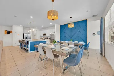 a dining room and kitchen with a table and chairs at The Venue Mansion in Kissimmee
