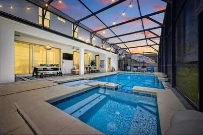 an indoor swimming pool in a house with a house at The Venue Mansion in Kissimmee