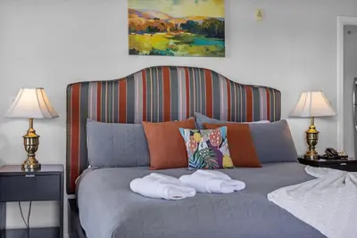 a bed with two towels on it with two lamps at Spacious Pet Friendly in Orlando