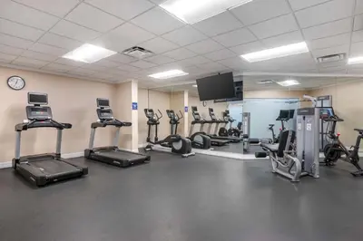 a gym with several tread machines and a flat screen tv at Hilton Vacation Club Cypress Pointe Orlando in Orlando