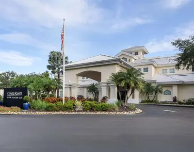 a hotel with an american flag in front of a building at Hilton Vacation Club Cypress Pointe Orlando in Orlando