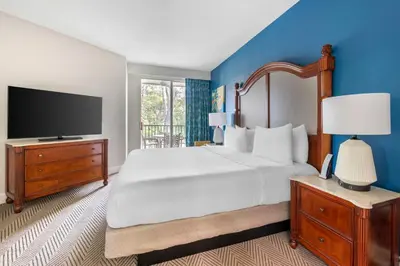 a bedroom with a large bed and a flat screen tv at Hilton Vacation Club Cypress Pointe Orlando in Orlando