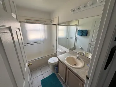 a bathroom with a sink and a toilet and a shower at Relaxing 3BR/2BA Home - Just 15 Minutes from Disney! in Kissimmee