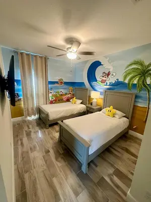 a bedroom with two beds and a painting on the wall at Best Margaritaville Villa Near Disney World in Orlando