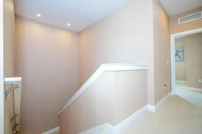 a hallway with a staircase in a house at Modern Magic Village Home for 12 with Grill 3131 in Orlando