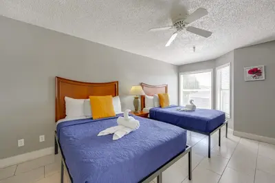 a bedroom with two beds with blue sheets and a ceiling at 2 Mi to Disney and Old Town Resort Condo with Perks in Orlando