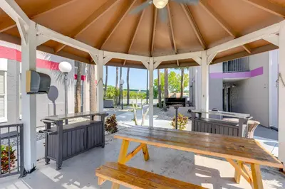 a pavilion with a wooden picnic table on a patio at 2 Mi to Disney and Old Town Resort Condo with Perks in Orlando