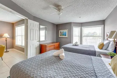 a bedroom with two beds and a window at 2 Mi to Disney Resort Condo with Pool Access in Orlando
