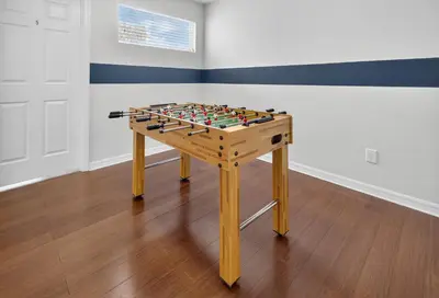 a wooden foosball table in a room at 290 LF - BellaVida Cozy 6BR Pool Home in Kissimmee