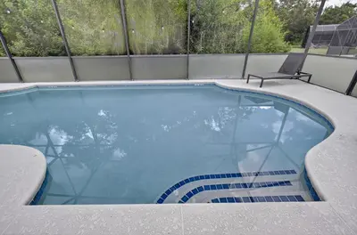 a swimming pool with a chair sitting on top of it at 290 LF - BellaVida Cozy 6BR Pool Home in Kissimmee