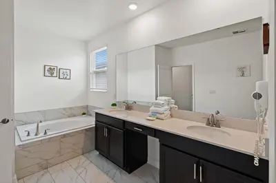 a bathroom with two sinks and a large mirror at 4238 Paragraph in Kissimmee