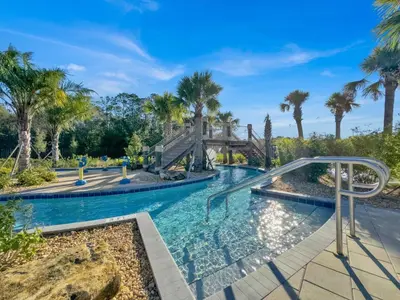 a swimming pool with palm trees and a slide at 4238 Paragraph in Kissimmee