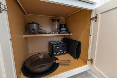a kitchen with a pan and a blender in a cabinet at Remote workers apartment or Long Stay Home