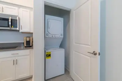 a kitchen with a refrigerator and a microwave at Remote workers apartment or Long Stay Home