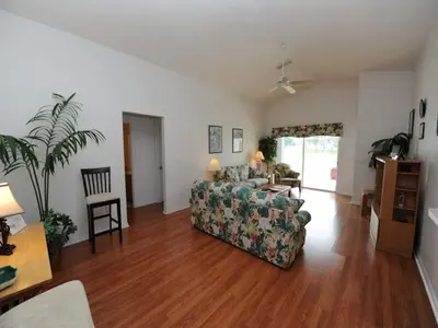 a living room with a couch and a table at Lake Therapy by Paradise Resort Vacations in Orlando