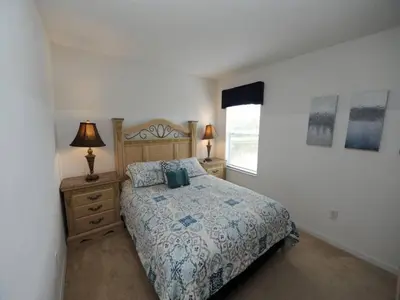 a bedroom with a large bed and a window at Sunset Bliss Escape by Paradise Resort Vacations in Kissimmee